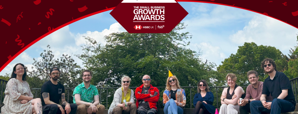 Smith Goodfellow team photo at Lyme Park out in the sunshine. This image has the Small Business Growth Awards logo in the centre and a banner across the top with confetti.