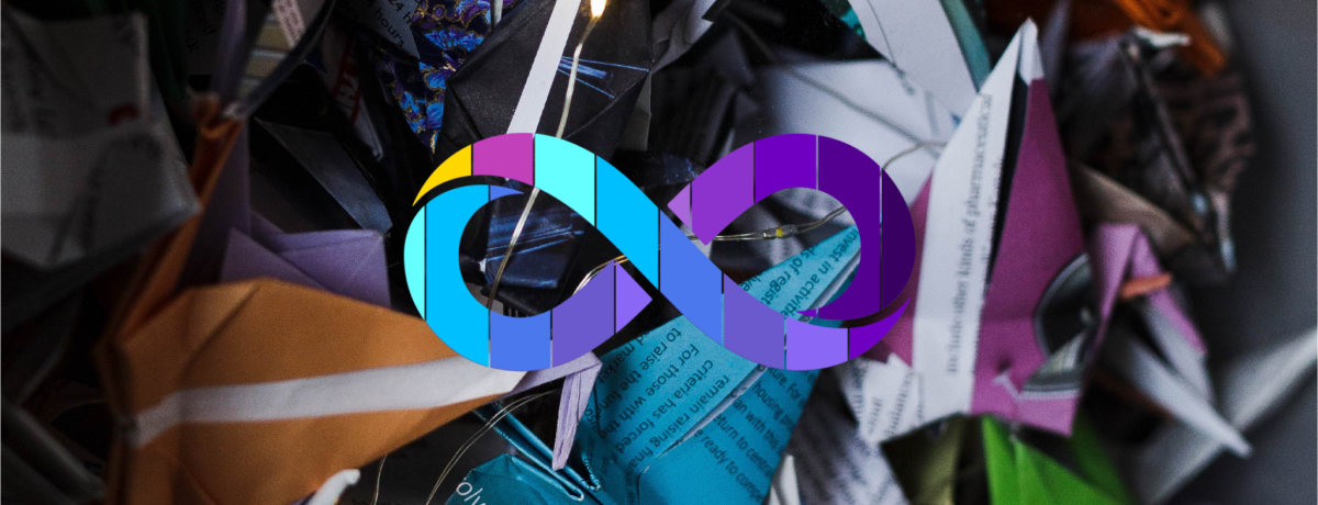 This image is a close up of origami cranes in lots of different colours with the Neurodiversity Pride logo which is a rainbow infinity loop to support this blog on inclusive recruitment.